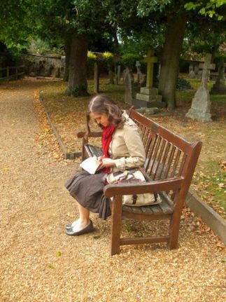 author r.a. nelson writing on bench